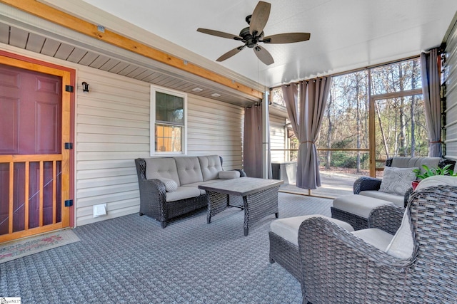 sunroom / solarium featuring ceiling fan