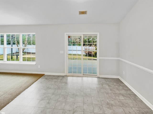 unfurnished room with light colored carpet, baseboards, and visible vents