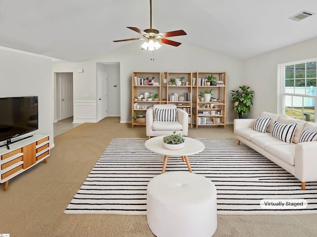 living area with lofted ceiling, carpet flooring, a ceiling fan, and visible vents