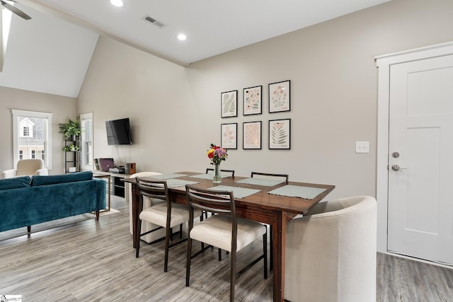 dining area with vaulted ceiling, light wood-style flooring, recessed lighting, and visible vents