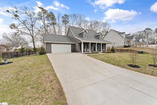 view of front of property featuring a front lawn, fence, a porch, a garage, and driveway