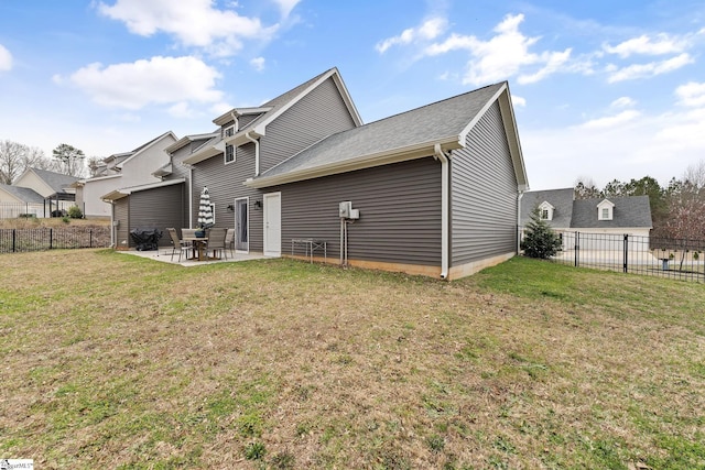 back of house featuring a yard, fence private yard, and a patio