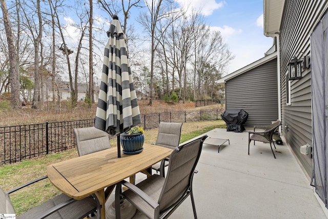 view of patio with outdoor dining space and a fenced backyard