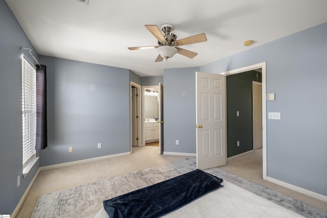 unfurnished bedroom featuring a ceiling fan, light colored carpet, baseboards, and connected bathroom