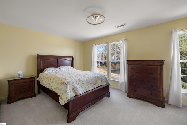 bedroom featuring light carpet and visible vents