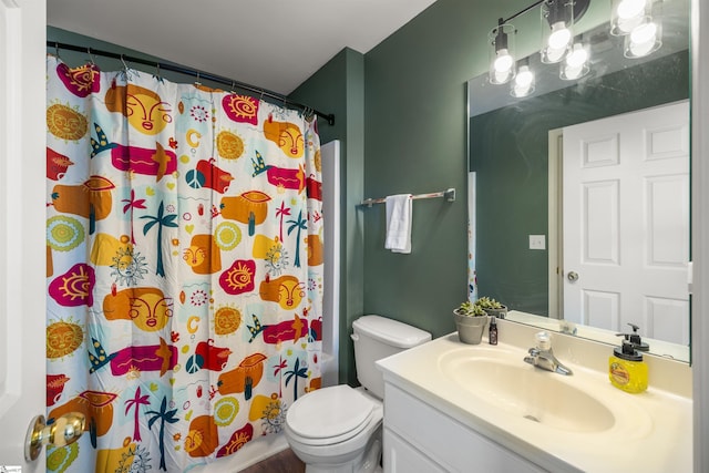 bathroom featuring vanity, a shower with shower curtain, and toilet