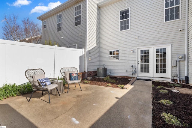 rear view of house with a patio, central AC, and fence