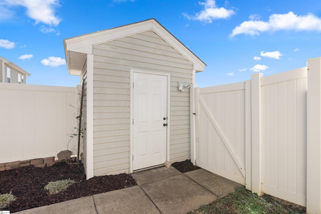 view of shed featuring a gate and a fenced backyard