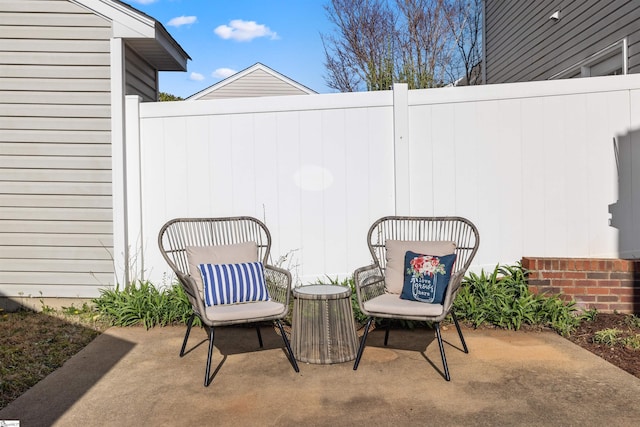 view of patio featuring fence