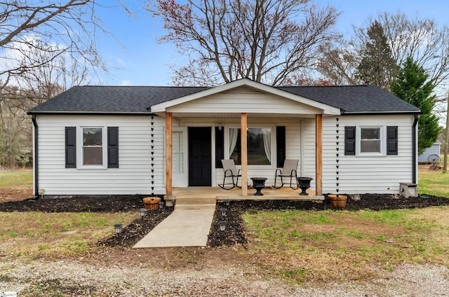 bungalow-style home featuring a porch and a shingled roof