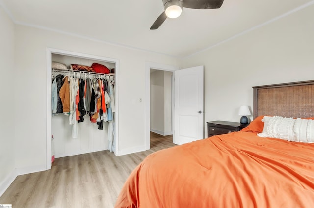 bedroom with a closet, baseboards, wood finished floors, and a ceiling fan