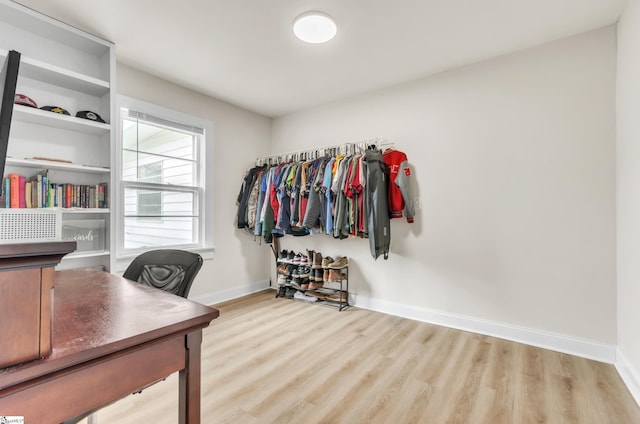 office area featuring light wood finished floors and baseboards