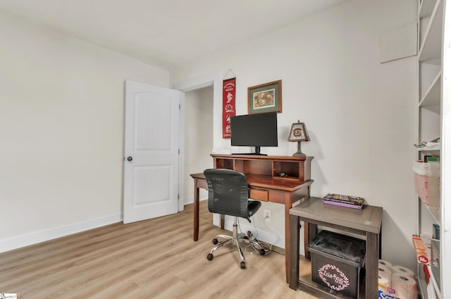 office space with light wood-style floors and baseboards