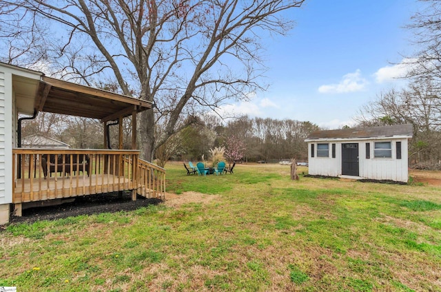 view of yard featuring an outbuilding and a wooden deck