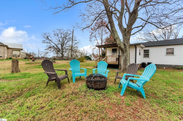 view of yard with a fire pit and a deck