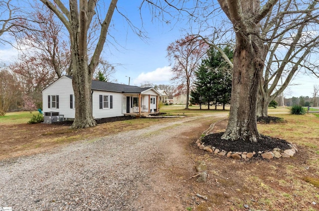 view of front facade featuring driveway and central AC