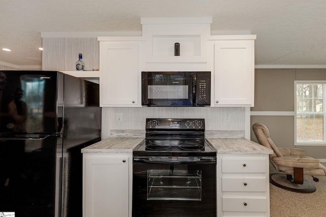 kitchen with white cabinetry, black appliances, and light countertops