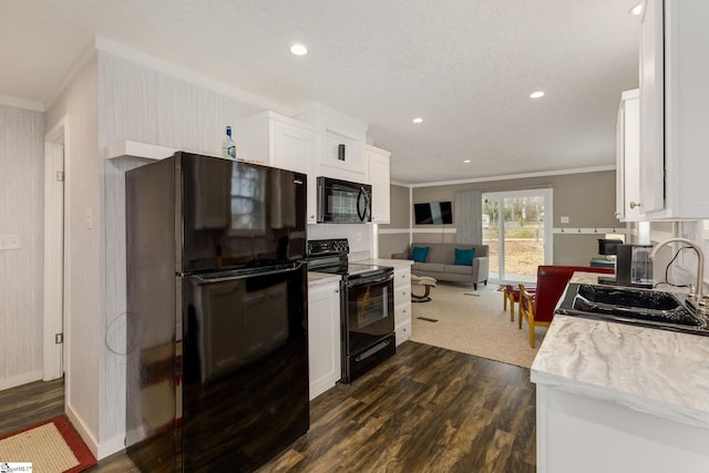 kitchen featuring black appliances, light countertops, ornamental molding, white cabinetry, and a sink