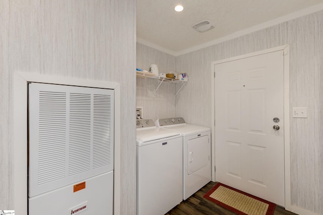 clothes washing area featuring visible vents, laundry area, a heating unit, crown molding, and washer and clothes dryer