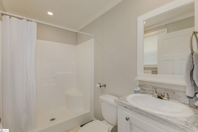 full bathroom with toilet, a stall shower, and vanity