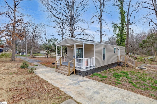 view of front of property featuring crawl space, a porch, and concrete driveway