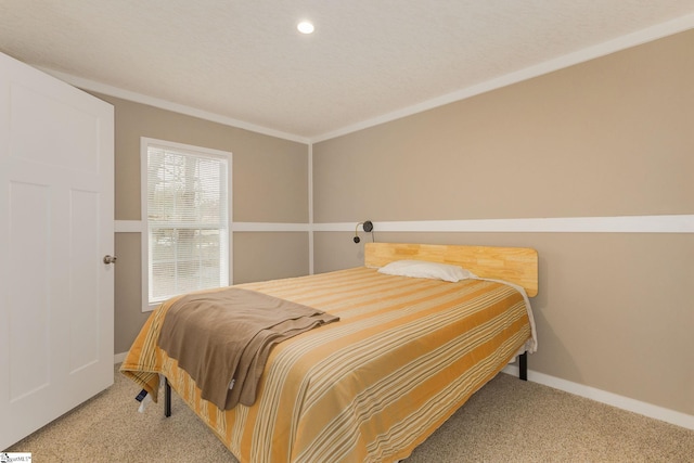 bedroom with carpet, baseboards, and ornamental molding