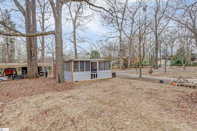 view of front facade featuring a carport and an outdoor structure