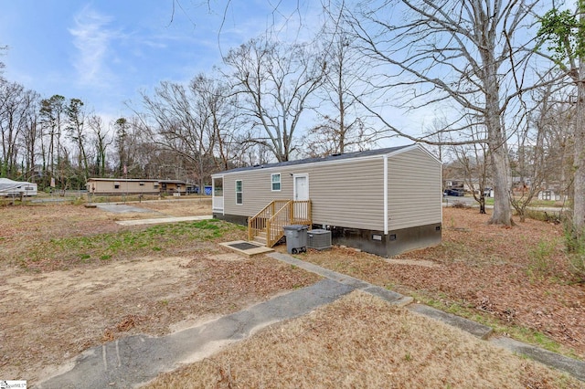 rear view of property featuring central AC unit