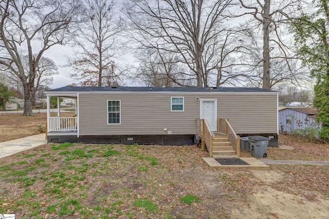 rear view of property featuring crawl space and entry steps