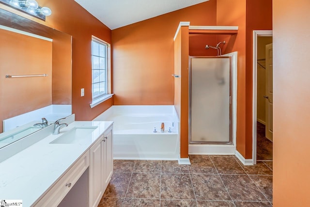 bathroom with vanity, a garden tub, baseboards, and a stall shower