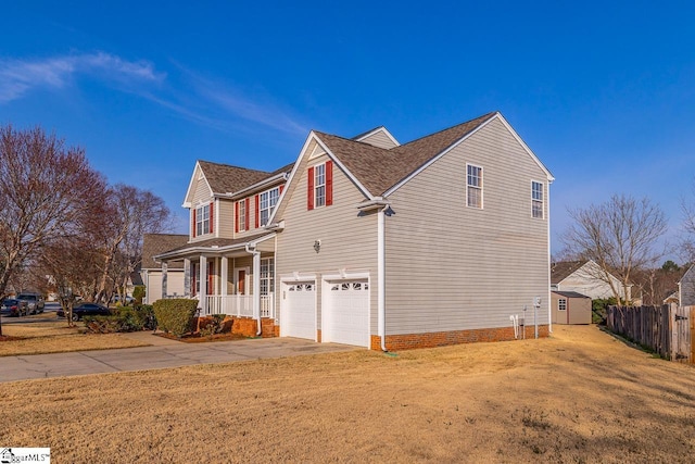 view of side of property with driveway, a lawn, an attached garage, and fence