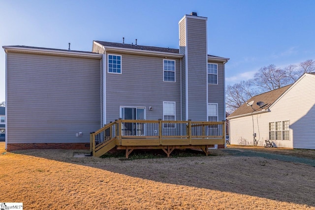 rear view of house featuring a deck and a chimney