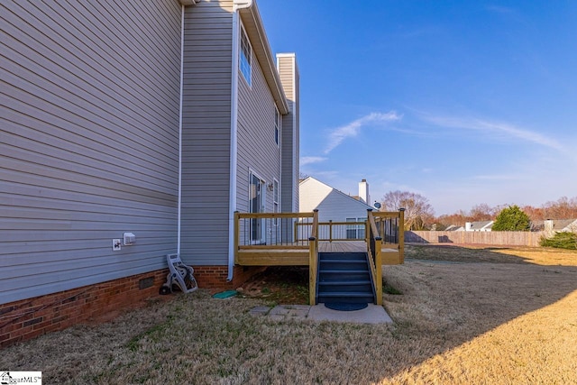 view of yard with a wooden deck, stairway, and fence