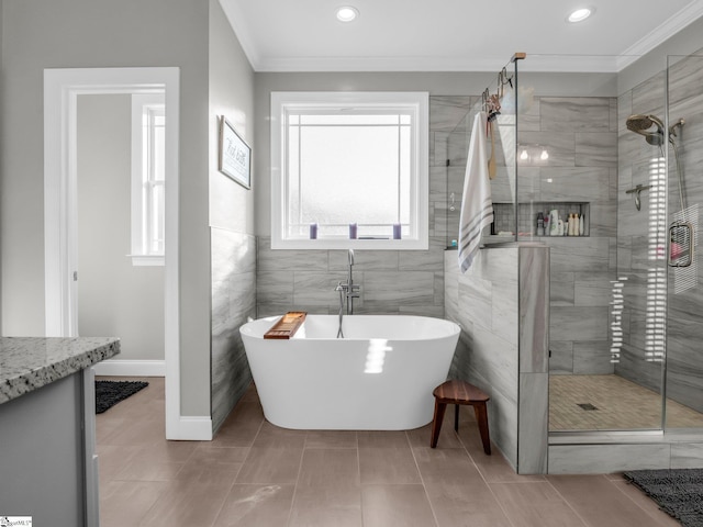 bathroom with crown molding, a soaking tub, recessed lighting, and a shower stall