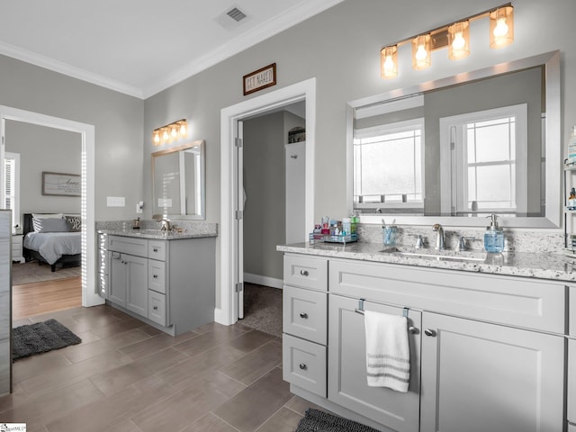 ensuite bathroom with visible vents, wood tiled floor, ensuite bath, a sink, and crown molding