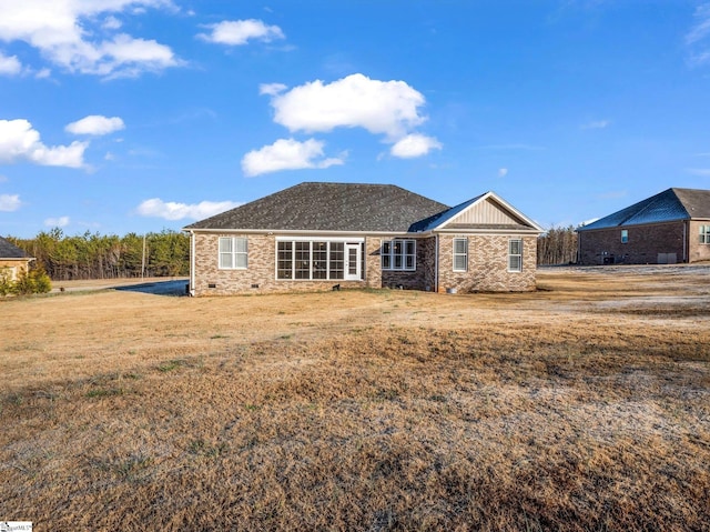 back of house featuring a yard