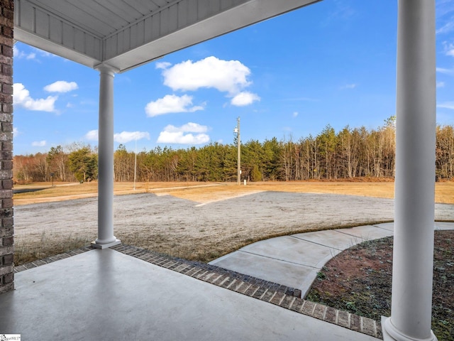 view of patio / terrace featuring a view of trees