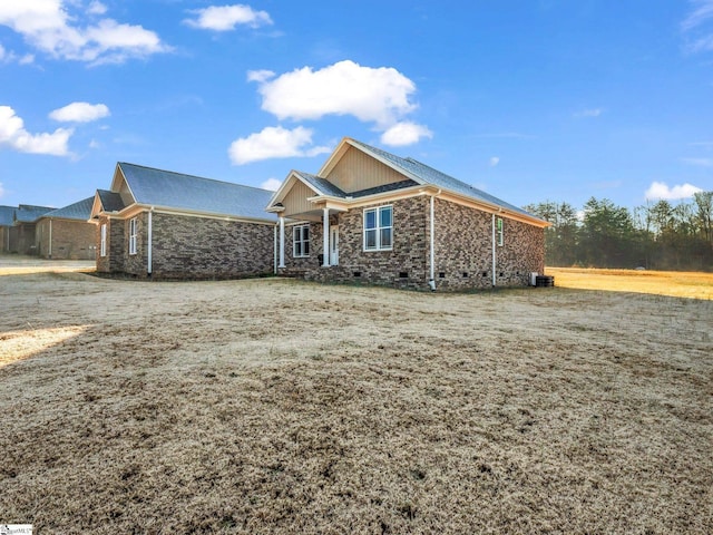 view of front of property with crawl space and stone siding