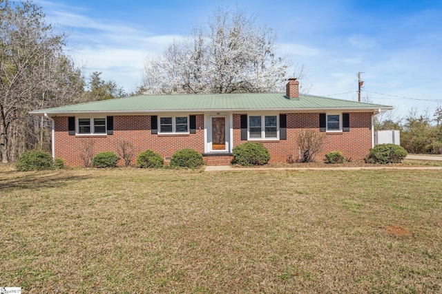 single story home with a front lawn, brick siding, a chimney, and metal roof