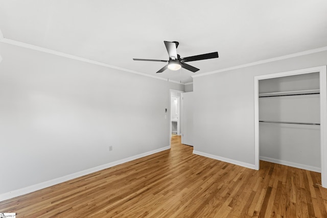 unfurnished bedroom with crown molding, baseboards, light wood-style flooring, a closet, and a ceiling fan