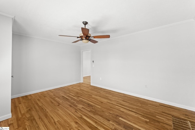 unfurnished room with crown molding, light wood-style flooring, baseboards, and ceiling fan