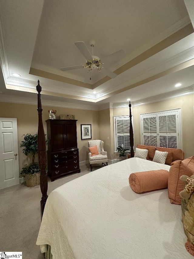 bedroom with a raised ceiling, light carpet, a ceiling fan, and ornamental molding