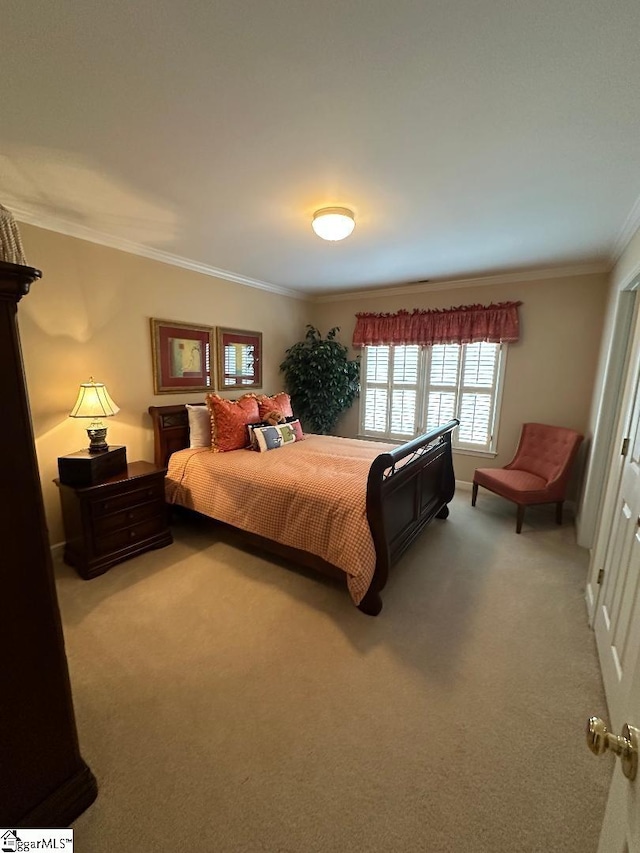 carpeted bedroom featuring baseboards and ornamental molding