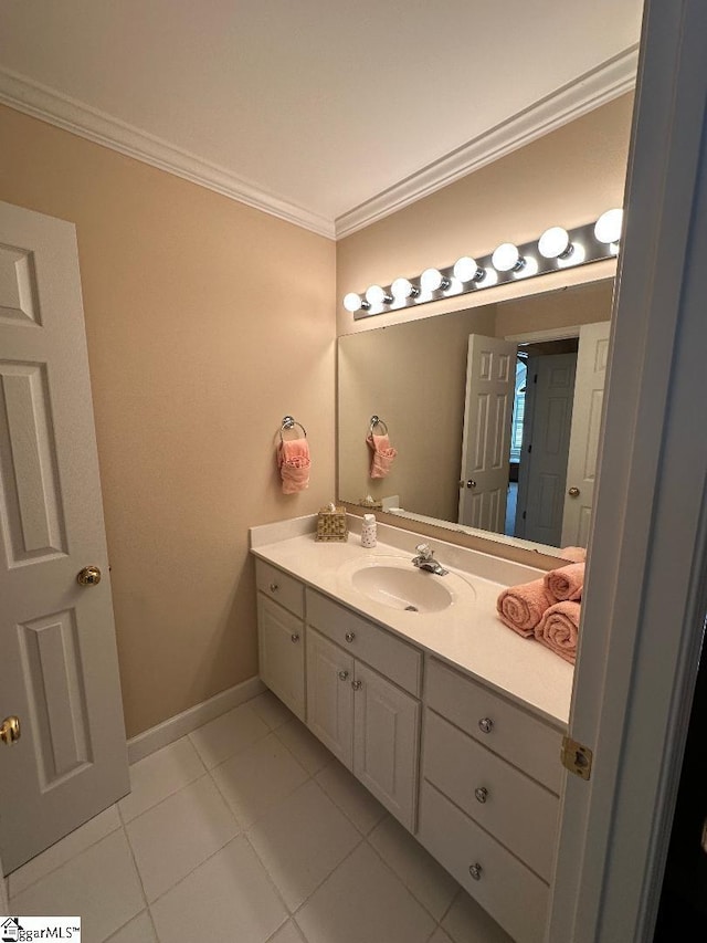 bathroom with vanity, crown molding, baseboards, and tile patterned floors