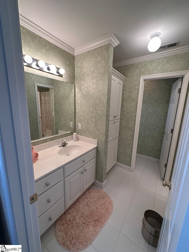 full bathroom with wallpapered walls, baseboards, ornamental molding, tile patterned floors, and vanity