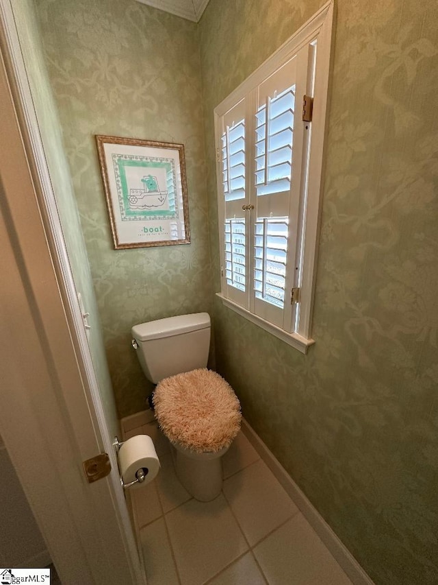 bathroom with tile patterned floors, baseboards, toilet, and wallpapered walls