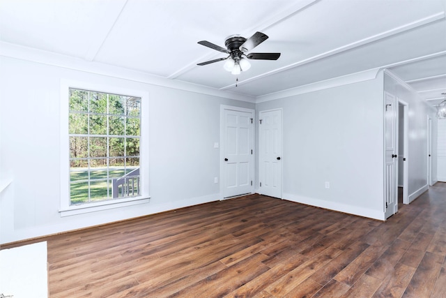 spare room with baseboards, wood finished floors, a ceiling fan, and ornamental molding