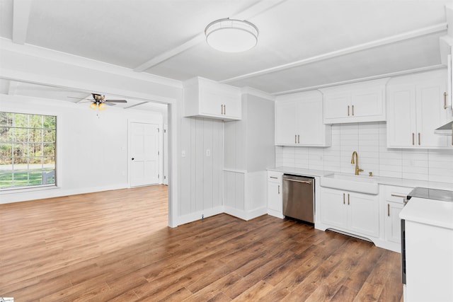 kitchen with tasteful backsplash, dark wood-style flooring, dishwasher, and a sink