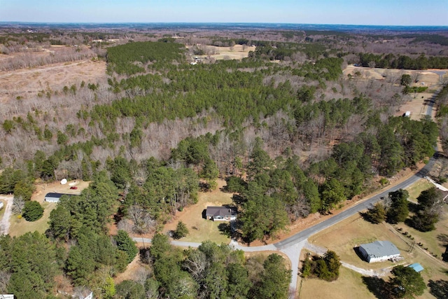 birds eye view of property featuring a wooded view