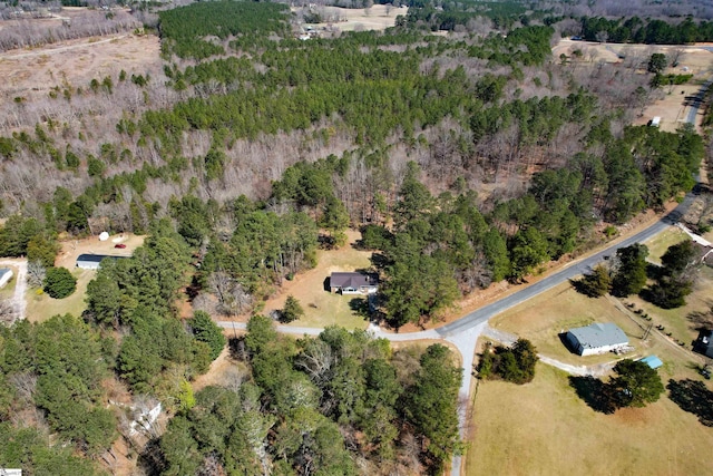 birds eye view of property featuring a wooded view